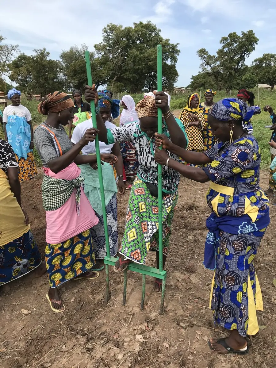Community members using an A-frame to mark contours for water harvesting